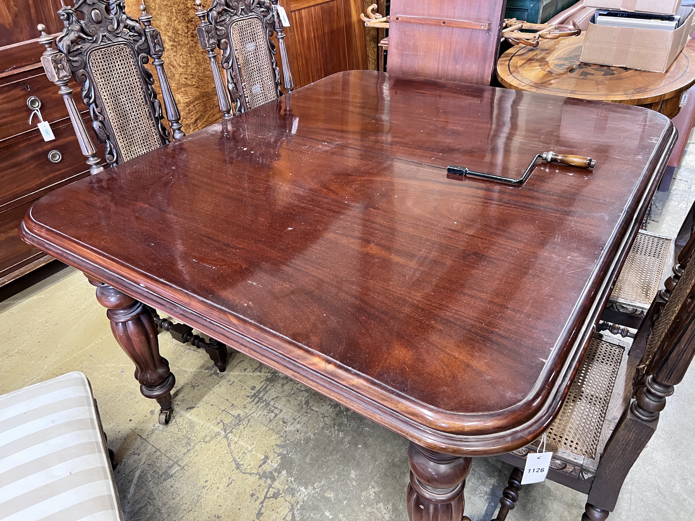 A Victorian style mahogany extending dining table, 235cm extended, width 124cm, together with a set of eight matching dining chairs